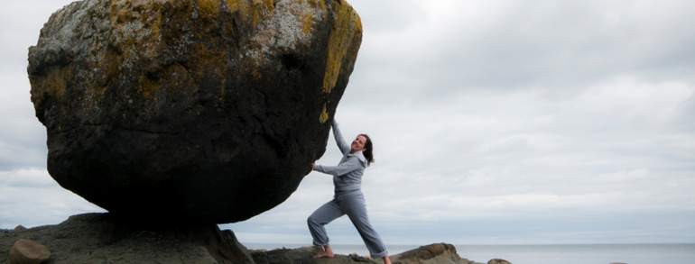 woman-holding-huge-boulder
